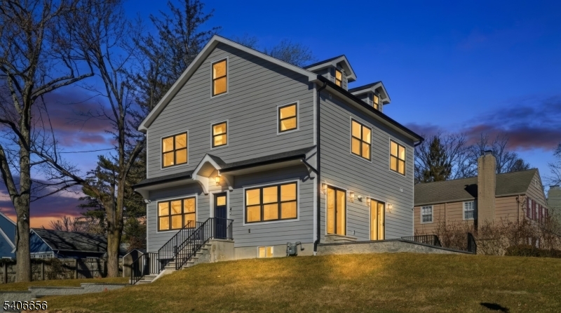 This NEW CONSTRUCTION Colonial is 4 beds 4 full bath and 1 half bath just completed and ready to move in. Hardie Plank exterior, Anderson Windows, paver driveway, paver patio,corner lot with large yard on both sides, 30 year timberline roof, 75 gal water heater, 2 Units 4 zones heat and AC, Smart Home all remotely controlled, speakers to the patio, new awnings over patio, fireplace in great room with brand new TV, open floor plan, hardwood select floors 3 1/2 wide, 9 foot ceilings, water purification system for drinking water,1 car garage with 10 foot door, large driveway 32 feet, laundry on 2nd floor, all Jenn Air appliances, Quartz counters, double sliders to paver patio, 2 electric panels, primary has WIC and large full bath and extra closet, 3rd floor bonus with full bath, basement has full bath, Across the street from highly ranked Essex Fells School... Just move in and enjoy