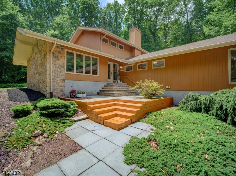 Welcome home to this updated custom contemporary home nestled on 3 acres & meticulously maintained & updated by original owners. This home features 4 BDRMS, 2.5 BATHS, 2 STORY FOYER entrance, cathedral ceilings & oversized 2 car garage. Huge primary en suite located on 2nd floor & gives a wonderfully calm & serene feeling as it has sliders that lead to a private balcony overlooking wooded yard. It also features a huge walk-in closet, completely remodeled luxurious bathroom w free standing soaking tub, glass enclosed shower stall & dual sinks. This beauty boasts over 3200 sq feet (per tax records) of living space w many windows creating an open, airy & bright atmosphere. Its architectural elements, decorative details & neutral color palette create a warm space w sophistication. Remodeled kitchen has sleek cabinetry, center island, granite ctops, glass backsplash, s/s higher-end appliances & separate dining area w sliders to entertaining-sized deck. Spacious FR also has sliders to deck, skylights, wood burning FP, vaulted ceiling & track lighting. Enjoy entertaining in the oversized living & dining rooms. 3 full bdrms (one with sliders leading to deck), full bath w tub & stall shower, renovated powder rm & newer LG washer & dryer complete the 1st floor. PEACE OF MIND here w NEW HVAC- 2021 & ROOF 2015, gutters & skylights- approx 5 yrs old. Property backs up to park land. Commuters dream--convenient to all major highways, train station, parks, shopping, restaurants, schools.
