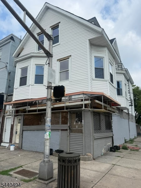Location, Location, Location! Exceptional investment opportunity on a highly visible corner lot at Park Avenue and East 33rd Street. This mixed-use property features two spacious residential units, each offering 5 bedrooms and 1 full bath, providing tremendous rental income potential. The first floor consists of a large vacant commercial space that previously operated as a laundromat, offering endless possibilities for redevelopment, owner occupancy, or potential business use. Buyers are encouraged to perform their own due diligence regarding permitted uses and any prior grandfathered approvals.The entire property is delivered vacant, making it ideal for investors, business owners, or owner-occupants seeking flexibility and value-add potential.Conveniently located near schools, parks, shopping, public transportation, and major highways. A rare opportunity to acquire a prominent corner property with substantial upside in one of Paterson's most desirable locations. Property being sold strictly as-is.