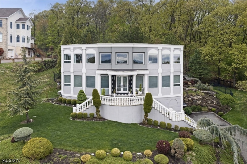 Custom-Built Home with Panoramic Mountain & NYC Views Private Setting at One of the Area's Highest ElevationsDesigned and built by the original owner and lovingly maintained for over 20 years, this custom-built 4-bedroom, 2.5-bath home offers a rare opportunity to own a one-of-a-kind property with breathtaking views and exceptional privacy. Set at one of the highest points in the area, the home features panoramic mountain and NYC skyline views and is filled with natural light from expansive windows throughout. The main level showcases a flowing layout with formal living and dining rooms, a spacious family room, and a kitchen that connects seamlessly to both perfect for everyday living and entertaining. A large custom pantry and powder room add functionality. Upstairs, you'll find four bedrooms, including a primary suite with private bath and a Jack & Jill bathroom serving the additional bedrooms. Laundry is conveniently located on the second floor. The outdoor space is a true highlight, offering a private backyard oasis with patio, fire pit seating for large gatherings, and a peaceful, retreat-like atmosphere. Additional features include a 2-car garage, bonus storage room above, central air and heat, and an unfinished basement with ample space.