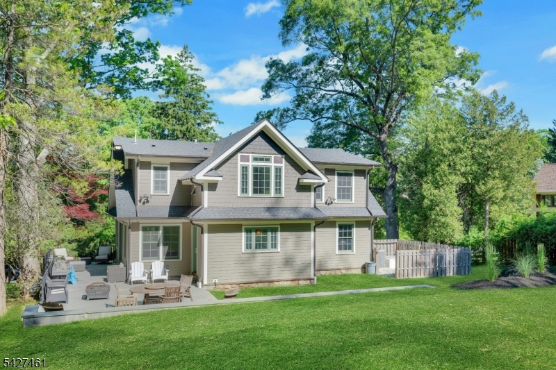 Charming 3/4-bedroom Cape Cod set on a beautifully landscaped property in desirable Randolph! This inviting home blends classic curb appeal with modern updates, featuring a stone-accented exterior, dormered roofline, and welcoming front entry. Inside, you'll find a warm and open layout with hardwood floors, recessed lighting, and abundant natural light. The spacious living room flows seamlessly into the dining area and stunning updated kitchen, complete with custom cabinetry, center island, and stylish finishes perfect for everyday living and entertaining. The home offers four generously sized bedrooms with flexible space for a home office or guest suite. Updated baths add a fresh, modern touch. Step outside to enjoy the serene setting with mature trees, tiered stone walls, and a private yard ideal for relaxing or hosting. Conveniently located near parks, top-rated schools, shopping, and major commuting routes, this move-in ready home offers the perfect combination of comfort, style, and location. A must see!