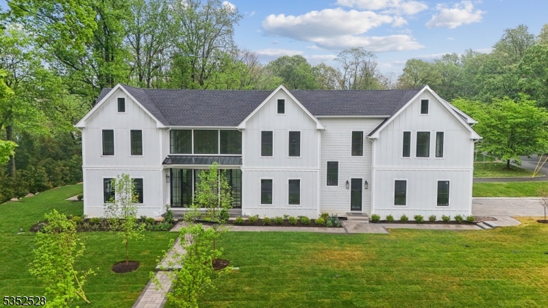 Designed by award-winning architect Thomas Baio and interior designer Karen Wolf of K+Co Living, this stunning new construction home in Short Hills checks all the boxes! Tucked away in the prestigious Poet Section, this newly constructed 7-bedroom, 7.1-bath home delivers exceptional design and luxurious living across four finished levels. A dramatic front foyer, framed by stunning Marvin glass windows, floods the space with natural light and architectural elegance. Inside, you'll find soaring ceilings, white oak hardwood floors, glass-railed staircases and custom trim throughout. The heart of the home is a chef's kitchen with solid custom cabinetry, quartz countertops, Subzero & Wolf appliances, dual Cove dishwashers, farmhouse and prep sinks, a custom backsplash, walk-in pantry, and an adjoining eat-in area accompanied by a formal dining room. The living room features a double-sided indoor/outdoor gas fireplace that opens to a patio, ideal for entertaining. Highlights include a private first-floor guest suite, cocktail lounge with wet bar, mudroom entry from an attached garage, and a finished third floor. The spacious basement includes a rec room with wet bar, gym and a theater-ready room. The second floor offers a laundry room, terrace, and a luxurious primary suite with vaulted ceilings, his & hers walk-in closets, and spa-like bath with soaking tub and stall shower. This home is the perfect harmony of refined luxury, thoughtful design, and everyday comfort.