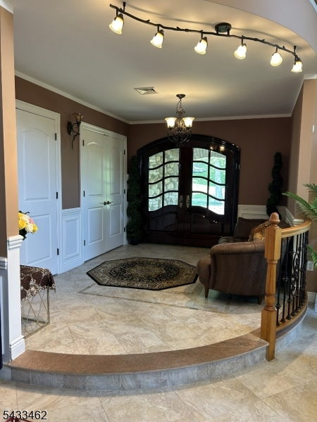 Custom-built, fully furnished contemporary single-family home for rent. This spacious residence features 3 bedrooms, each with its own private full bathroom, plus an additional room without a closet that can be used as a 4th bedroom or office. In total, there are 5 full bathrooms and 1 half bath.  Enter through the foyer into an elegant living room with soaring two-story ceilings, oversized windows providing abundant natural light, a stunning chandelier, and a gas fireplace. A bi-level staircase or private elevator leads to the next level.  The oversized kitchen/dining area features vaulted ceilings, custom cabinetry, quartz countertops, and a large center island.  Sliding glass doors open to a patio with breathtaking mountain views. Off the kitchen is a walk-in pantry/laundry room with an additional cooking area and a convenient half bath. The primary suite is also located on this level and includes a private bathroom with a jacuzzi tub, bidet, stand-up shower, walk-in closet, and sliding doors leading to a private enclosed porch.  Upstairs are 2 additional bedrooms, each with its own private bathroom, plus a bonus room ideal for a bedroom/office. A veranda overlooks the main living area below.  The lower level features a huge recreation room perfect for entertaining, complete with a pool table, foosball table, and access to the ground-level porch, ideal for BBQs and outdoor gatherings.  Additionally there is a 2-car built-in garage, a gated driveway, with ample parking.
