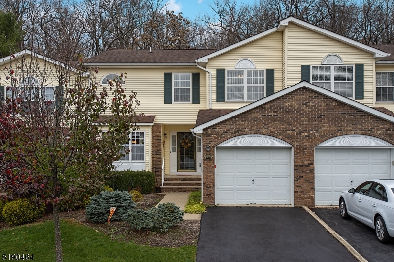 This spacious townhome is located in the Timber Valley Complex (on the Franklin Lakes border of Wayne). This home boasts lots of natual light and has a large deck that overlooks greenery and trees for your utmost privacy. The first floor includes: a large entry foyer; an Eat in Kitchen with a breakfast area, tiled backsplash, wood cabinets and newer stainless steel appliances; a formal DR; Living Rm with hi hats, a skylight, and a wood burning fireplace; a separate laundry room with a bonus closet that can be used as a pantry; powder room; and entrance to the garage.The second floor has hardwood floors throughout (except the office) and includes the main BR with both a wallk -in closet and a second closet, an Ensuite bath with jetted tub, separate tiled walk in shower, overhead heat lamp, and double sinks. There is also a second BR and full hall bathroom with a tub/shower combo and overhead heat lamp. An office is also on this level and can be easily converted to a 3rd BR if needed. A partially finished basement that has hi ceilings, hi hats, 2 finished rooms that include a family room and an office, as well as  lots of storage complete the lower level. Come take a look... this lovingly cared for home will not last long!