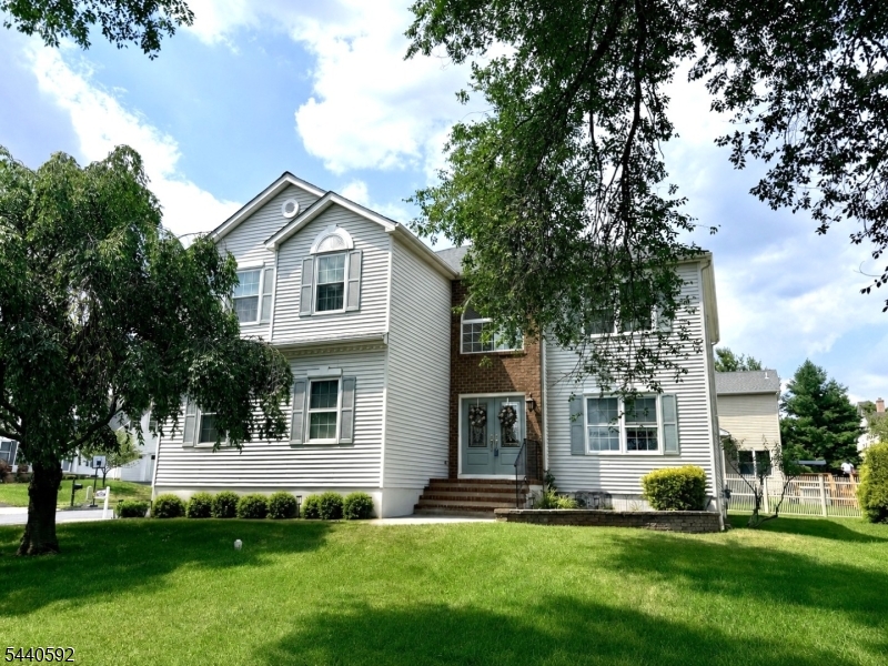 Meticulously maintained and thoughtfully updated by its original owners, this modern Bridgewater colonial seamlessly blends elegant design with everyday comfort. An abundance of natural light floods the dramatic two-story foyer and spacious family room, anchored by a cozy corner gas fireplace. At the heart of the home is a stylishly renovated kitchen, boasting premium quartz countertops, stainless steel appliances, a custom tile backsplash, and high-quality cabinetry with decorative open shelving. Gleaming hardwood floors flow throughout the main level. Upstairs, the primary suite is a private retreat, featuring airy cathedral ceilings, twin walk-in closets, and a renovated ensuite bath complete with a double vanity, standalone soaking tub, and a separate stall shower. The fully finished basement adds versatile recreation space, with open areas, nooks for separate uses, and ample storage. Outside, the private backyard features an expansive deck accessible right off the kitchen slider, perfect for relaxing or outdoor dining. A premium paver stone driveway, matching walkways, and manicured landscaping deliver impeccable curb appeal from the moment you arrive. Centrally located, in absolute move-in condition, this home is an exceptional opportunity.