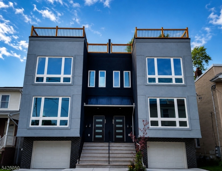 Introducing a standout opportunity to own in one of Essex County's most exciting new construction developments. This modern, attached two-family residence (LEFT side) is thoughtfully designed for today's lifestyle, offering the perfect blend of luxury, functionality, and strong investment potential. This spacious home features 6 bedrooms, 4 full bathrooms, and a private two-car garage, making it ideal for both owner-occupants and investors seeking high-quality rental income. The ground level offers a versatile recreation space with direct backyard access perfect for entertaining, working from home, or accommodating guests. Inside, you'll find sleek, contemporary finishes, appliances, and a clean, modern design that elevates every room. The full rooftop terrace serves as a true highlight, providing a private outdoor retreat with expansive views ideal for relaxing or hosting gatherings. To make this opportunity even more attractive, the seller is offering a buyer credit along with assistance navigating the 5 yr tax abatement process. Additional upgrade packages are available for the rooftop and rec room, allowing you to customize features to suit your style. Conveniently located near major transportation, shopping, and local amenities, this development is positioned for growth and demand. This is more than just a home it's a smart investment and a chance to be part of Irvington's evolving landscape. Schedule your private tour today! Home is virtually staged. Builder's Warranty