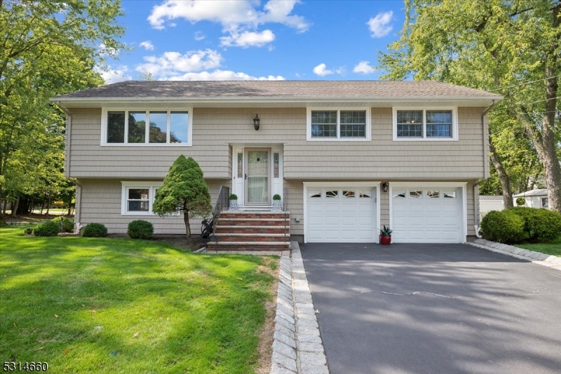 Impressive ready to move Bi-Level in a fantastic, tranquil neighborhood of River Vale with 3 bedrooms, 2 full baths, 2-car garage, and many upgrades. Beautifully landscaped corner lot just blocks away from Westwood Avenue and Rivervale Road with tons of shopping and dining options, plus top schools, NJ Transit, and multiple parks. The main level of this gorgeous home is highlighted by gleaming hardwood floors and a sun-drenched living room with open flow into a formal dining room and adjacent updated kitchen, creating a comfortable and inviting atmosphere. Meal prep will be a joy in this chef's kitchen equipped with an oversized center island, stainless steel appliances, and rich wood cabinetry topped with granite. Wood floors continue down the hall to 3 generously sized bedrooms including a large primary, all serviced by a hall bath with storage vanity and tub/shower combo. There's even more living space in the lower level, offering a sprawling walkout rec room perfect for movie nights or informal entertaining, a second full bath with shower stall and laundry closet, and access to the incredible finished attached garage with tons of space, epoxy floors and ample built-in workshop storage, and utilities room that includes a tankless water heater. Enjoy summer cookouts, gardening or playing games in the lush backyard, with a paver patio off the rec room ideal for sipping coffee or cocktails. Stunning move-in ready home in a great area, nothing to do here but unpack!