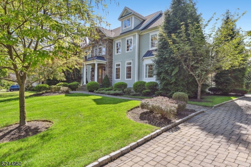 Essential elements of this modern Colonial, circa 2010, creates a residence conducive for formal entertaining, while accommodating casual living style. First impression is the open, flowing floor plan along with sophisticated architectural amenities featured in elaborate millwork, hardwood floors, higher ceilings, spacious rooms , as well as a front and side staircase. The image of the residence expresses its own personality in the luxurious scale and proportions. First Floor features a Living Room, Dining Room, Family Room with a gas fireplace, Guest Room and Hall Bathroom.  The heart of the home is a Chef's Kitchen with Center Island  and Breakfast Area distinguished by clean lines of custom white cabinetry, high-end stainless steel appliances, marble subway tiled backsplash and numerous stone workstations. Second Floor offers a sumptuous Primary Suite  with Bedroom, Bathroom, Dressing Room and Sitting Room along with Bedroom 2 ensuite with Bath, two additional Bedrooms sharing a Bathroom and Laundry Room.  Downstairs,  the lower level includes flex space in the Recreation Room, Game Room, Pool Room  and Fitness Center.  Picturesque  grounds, .56 acres, provide an arboretum appearance enriched with specimen plantings, plush lawn and mature trees. The impressive outdoor setting includes paver-stone walkways, rear patio and driveway.