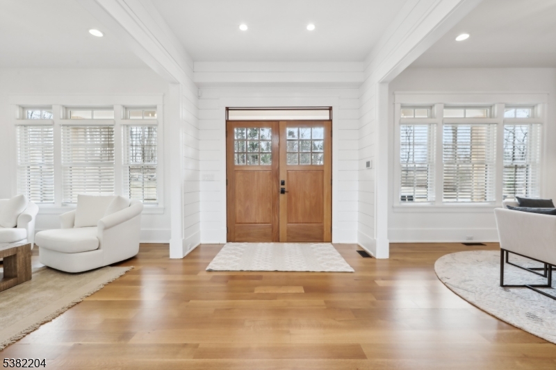 Enjoy a magnificent 2 year old home with 10ft first floor ceilings on 6 acres at the end of a private road. Taxes only $38,857. This McCann-built masterpiece, provides privacy and a convenient location in New Vernon NJ! The thoughfully designed floor plan offers multiple living options, with two primary suites; one on the main floor and one on the second level both featuring sleek linear gas fireplaces. The home also includes several bonus rooms ideal for office and flex space, including one above the 3 car garage with a separate entrance. The stunning kitchen has chef grade appliances, an oversized island, farmhouse sink, and Vikiing range. There is a Wet-Bar in the dining area and in the main floor primary, and the LL. Each of the 7 brs are en-suites including in the LL which is fully finished entertainment space including a wine room, theatre area with a wet kitchenette, a play area and for fitness enthusiasts, a professional grade fitness room with rubber flooring, a wall of mirrors and equipment included. The main level opens to the back deck with beautiful brick pavers, an outdoor kitchen with expansive fenced in yard finished with a beautiful deep blue fiberglass pool. Exquisite millwork ship-lap and distressed wood accent walls finish the interior. 12-15 minutes to Morristown & Summit, outstanding private schools, Morristown airport, NJ Jets training facility, Overlook and Morristown medical centers, trains to NYC, and incredible restaurants.