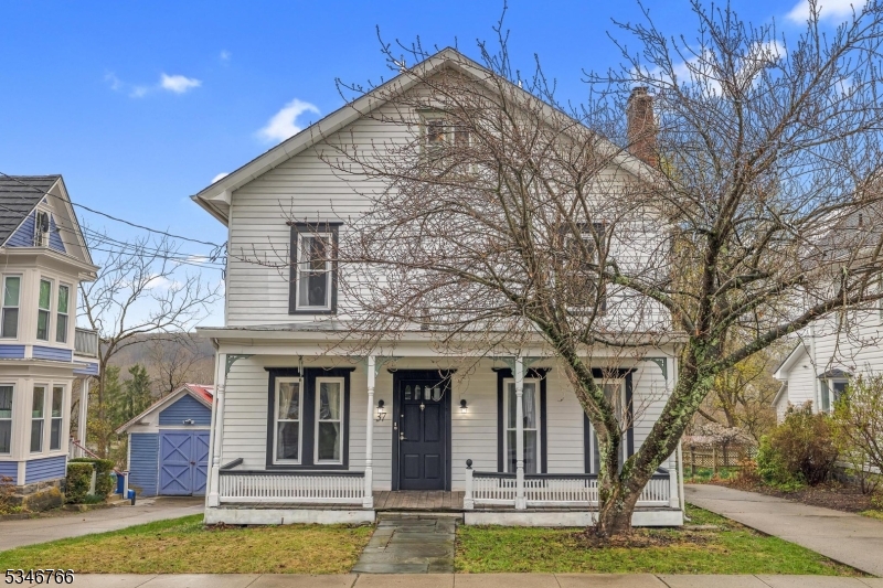 Charming 4-bedroom, 2.5-bath historic colonial with a spacious office, located in the downtown area of quaint Blairstown. This home features an updated kitchen and baths, including a stainless steel farm sink, dishwasher, and white cabinetry. Enjoy beautiful engineered hardwood floors on the main level and luxury vinyl plank flooring upstairs. With covered front and rear porches, you'll have plenty of space for outdoor relaxation. With a driveway on each side of the house along with on-street parking, you'll have plenty of space for visitors! The detached 2-car garage includes a workshop, and the property boasts a new septic system, thermal windows, and white aluminum siding. Public water adds convenience. A perfect blend of classic character and modern upgrades!