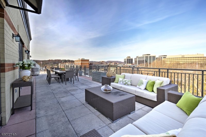 On top of the world! 40 Park's most desirable penthouse- Unit 703-downtown Morristown's premier, one-of-a kind residence offers stunning, panoramic views facing the Green and unparalleled privacy, luxury, and convenience. Prized, top-floor location with 1,800+ sq ft wrap around terrace with private Dehart Street underground assigned parking, discreet piazza courtyard rear entrance, concierge services, exclusive elevator access to 7th floor, and premium amenities including Club Room, fitness center, and full catering kitchen.  7 rooms, 3 bedrooms, spacious den, 3 1/2 baths and brimming with special design features- this home offers a superb 2,780 sq ft open floor plan, including a spectacular 1,820 sq ft wrap around terrace overlooking Morristown skyline. Life at the top doesn't get any better than this!