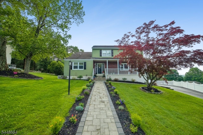 Welcome to your West Milford dream home. This center-hall-Colonial style home offers ease of living and serene space. As you approach the lemonade porch you'll find a new paver walkway leading to the front entrance and welcoming foyer. The first level of the home offers new hardwood flooring making it a seamless space to entertain. The formal dining and living rooms provide plenty of space for guests, while every-day living is made easy in the open-floor plan family room and updated eat-in kitchen with granite counters, stainless steel appliances, wine refrigerator, and soft-close cabinets. Rounding out the first floor is a full bathroom and spacious laundry room with attached pantry. On the second floor, you'll find a primary bedroom with California closets and an updated ensuite bathroom with a frameless glass shower. Three additional bedrooms and a tastefully updated hall bathroom complete the second floor. On the lower level you'll find an expansive unfinished space awaiting your vision with storage and direct access to the two-car attached garage. The outdoor oasis is the standout of the home with a maintenance-free deck overlooking the patio, bar, salt-water pool with a new liner and heater. The property is truly move-in ready offering new central air conditioning, a whole house generator, in-ground five-zone sprinkler system and exterior French drains. This is truly a home that is ready to house all of your future memories.