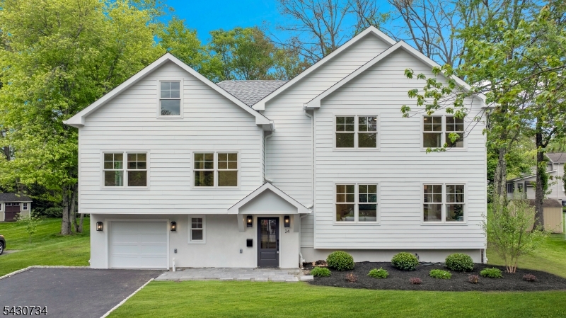 Experience luxury living in the heart of New Providence with this stunning new construction home by NWS Construction and Dana Marceline Design. This exceptional 6-bedroom, 4.5-bath residence features timeless transitional design across six finished levels. The open-concept main level BOAsts 9' ceilings, abundant natural light, and a two-sided fireplace connecting the family room and chef's kitchen, which includes quartz countertops and a spacious center island. Enjoy seamless indoor-outdoor living with sliding doors that lead to a Trex deck overlooking a serene backyard and Cambridge bluestone patio. The entry level features a mudroom with custom built-ins, powder room, and spacious in-law suite.The second floor offers three bedrooms, including one en-suite, full hall bath, and laundry room. The third floor features a luxurious primary suite with walk-in closet and spa-like bath with soaking tub, dual vanity, and oversized shower, plus an adjacent bedroom ideal for an office or sitting room. Additional living space includes a finished fourth-floor flex space and finished basement recreation room with storage. Conveniently located near the train station, vibrant downtown, and nearby parks, this home offers the perfect blend of luxury, comfort, and convenience.
