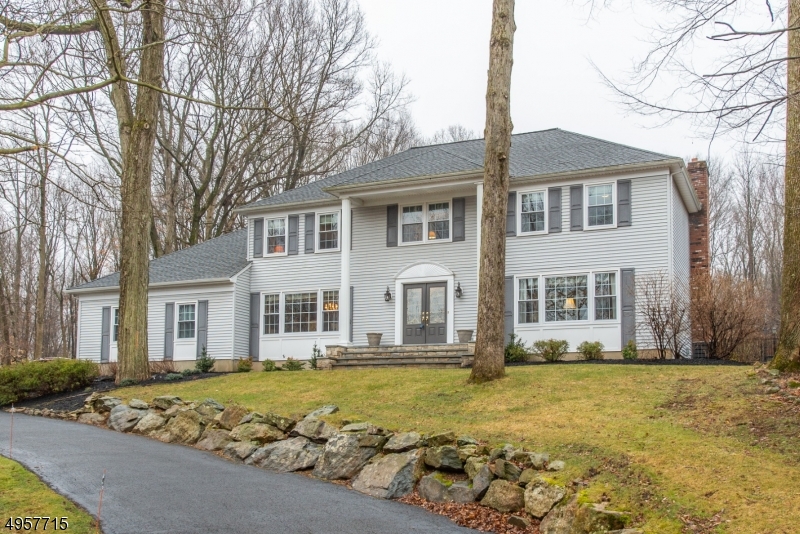 Shows like a model!! Meticulously maintained 5 bedroom colonial on cul-de-sac features open concept living. New front paver walkway/porch lead inside to family room w/ new floor-to-ceiling stone fireplace, wet bar, & built in bookcases. New kitchen w/ custom cabs, large island w/ seating, granite counters, SS appliances & large wall of custom cabs for storage & display. New HW flooring & detailed woodwork round out the first floor including a 5th BR/office featuring custom cherry cabinetry & cherry wood floor. Second floor has 4 spacious bedrooms w/ large closets, closet organizers & updated baths.  An outdoor oasis awaits w/ private wooded yard, gardens, in-ground pool, large deck/gazebo. Finished basement, walk in attic w/ abundant storage, new 50 year roof, new windows, & public utilities.