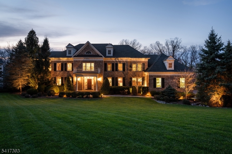 Welcome to a one-of-a-kind custom residence where no expense was spared and every detail was thoughtfully designed. Perfectly positioned on a quiet cul-de-sac in the heart of Watchung, this meticulously maintained home has been professionally landscaped and showcases a stately four-sided brick facade. With steel beam construction, you'll have confidence in owning this home for years. The thoughtfully designed floor plan features ensuite baths in every bedroom, including a desirable first-floor ensuite with French doors opening to an oversized deck. The chef's kitchen is truly spectacular, highlighted by a 10-foot center island, custom stone moldings, & high-end commercial-grade appliances. A first-floor office has rich mahogany built-ins & a gas fireplace, creating an inspiring workspace. The luxurious primary suite offers a private retreat with a sitting room, a gas fireplace with remote start, two custom walk-in closets, and a spa-like bath. The walkout lower level lives like its own residence, complete with a custom wood bar, wine cellar, full bath, gym, game room & a wall of windows overlooking the private backyard. Enjoy seamless indoor-outdoor living with a covered patio, expansive deck, and flat, fenced yard ready for your future pool and backyard oasis. You won't want to miss this superiorly constructed home. The approximate square feet include the finished walk-out lower level.