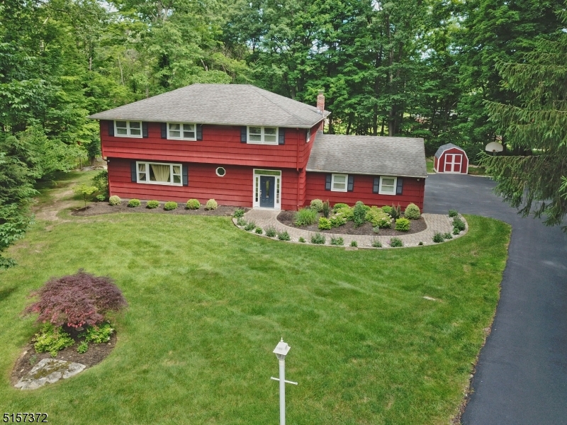Welcome to 5 Cairn Court in the sought after section of Glenbourne Estates.  This meticulous Colonial style home is located on a cul de sac on 1.35 acres. Appreciate the lush landscaping, paver walkway and freshly paved driveway in this quiet neighborhood.  Unlock the front door to a welcoming foyer entryway that opens to the living room area. Large eat-in kitchen which includes granite countertops and stainless steel appliances. The large bay windows look out to a lovely private wooded area. Adjacent to the kitchen step down to the family room which includes French doors that open to an outdoor covered porch.  Large private yard.  This gem has 4 spacious light filled bedrooms and 2 baths located on the second floor.  Large master suite with remodeled bathroom in 2022 that includes quartz countertops, new vanity, lights, tile, and shower stall with barn door enclosure.This home contains hardwood floors throughout.  Additionally, this home includes large unfinished basement with high ceilings just waiting to be finished for additional living space.Includes Public utilities, well water, 2 car garage, shed for extra storage.Close proximity to shopping, transportation, and major highways.Highly rate school systems including Rockaway Valley Elementary School K-8 and prestigious Mountain Lakes High School.