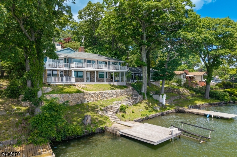 Welcome to this beautifully renovated lakefront retreat offering breathtaking views of Lake Hopatcong. Thoughtfully updated throughout, this stunning 4-bedroom, 2 full bath home features high-end finishes, an open-concept floor plan, updated bathrooms, modern fixtures, and stylish design elements that create a move-in-ready living experience. Expansive windows flood the home with natural light while showcasing spectacular lake views from nearly every room. Multiple balconies provide the perfect setting to relax, entertain, and enjoy the waterfront scenery. Situated on 100 feet of prime Lake Hopatcong waterfront, the property includes a private dock and boat lift, making it ideal for boating, fishing, swimming, and enjoying everything lake life has to offer right from your backyard. Whether you're looking for a year-round residence or a weekend escape, this home offers the ideal blend of luxury and comfort
