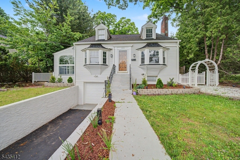 Step into this exceptional 4 BR, 4-bath Cape thoughtfully redesigned with high-end finishes, offering the perfect blend of sophistication, comfort, and flexible living space. The heart of the home is the Kitchen feat new appliances designed for everyday living & entertainment. Natural light is enhanced by striking Palladian windows & beautiful architectural details throughout. The LR boasts striking arched windows gracing a stately stone wood-burning fireplace. The inviting all-season room features skylights & newer Palladian windows & opens to a spacious wraparound deck perfect for indoor-outdoor entertaining. The primary suite feat cozy fireplace & dual closets. Barn door entry to breathtaking spa-inspired marble bath complete with frameless shower & panel system, freestanding soaking tub, decorative framed his/her mirror cabinets, premium bidet & private sauna. 2nd BR offers a renovated en-suite bath. Every bath in the home has been newly renovated with upscale designer finishes & modern elegance. Main floor feat 2 BRs with a newer Bathroom. Fully finished walkout lower level expands the home's versatility with a newly renovated private full bath & 2 separate office spaces. Add'l major upgrades incl new boiler/heating system, whole-house mini splits, hot water heater, and a roof, providing peace of mind for years to come. Private setting with expanded rear parking. This exceptional home offers incredible combination of luxury, functionality, & comfort inside & out.