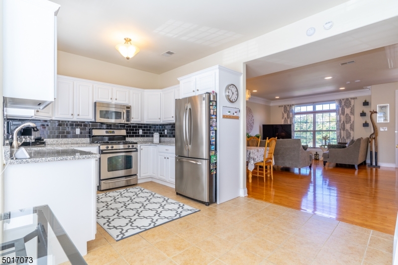Stunning and updated multi floor townhouse in the heart for Rahway! Bright and airy first floor with open concept living room and dining room, hardwood floors, neutral color walls, powder room, and lots of closet space. Gorgeous eat in kitchen with SS appliances, granite counter tops, and spacious pantry. Laundry room/ utility room on first floor with plenty of storage. Second floor with 2 great size bedrooms, including master with full bath, walk in and additional closet. Another full bath on second floor and an additional room used as an office with endless possibilities. Central heating and cooling. All appliances included with sale. Nothing to do but move in. Excellent location, walking distance to train station and downtown Rahway. Easy access to major highways. A must see!!!