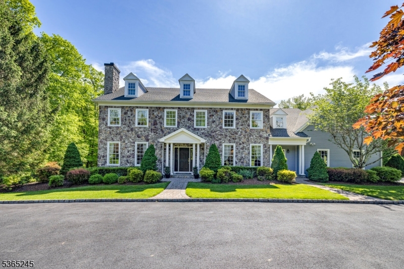 This stunning home exudes warmth, natural light, and timeless elegance throughout its 15 spacious rooms. With 5 bedrooms, 4 full bathrooms, 2 half baths, and soaring 9-foot ceilings, creating an ideal environment for both everyday living and entertaining. Impeccable craftsmanship, with custom woodwork, rich hardwood floors, refined moldings, and crisp designer paint.  A beautifully designed chef's kitchen, featuring Sub-Zero and Thermador stainless steel appliances. This space opens seamlessly to the inviting family room, where French doors lead to a gorgeous, expansive 2-level patio overlooking the professionally landscaped backyard.A spacious mudroom just off the kitchen adds convenience and functionality to the main level. Upstairs, the 2nd floor boasts 5 generously sized bedrooms, including an expansive primary ensuite complete with luxurious spa-like finishes and large walk-in California Closets.The finished basement is a showstopper, offering high ceilings, a full bathroom, an impressive custom bar with 2 wine refrigerators, and dedicated exercise room. The 3-car garage is outfitted with a full GarageTek system, and recent upgrades - new driveway, new garage doors, and generator which add even more value.Located within a highly sought-after neighborhood, this property is served by nationally recognized Blue Ribbon elementary and middle schools, and a top-rated high school known for its rigorous Advanced Placement and International Baccalaureate (IB) programs.