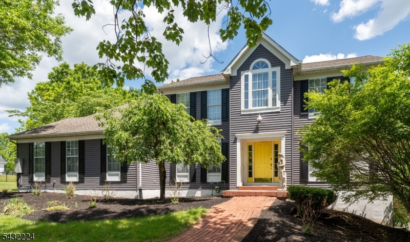 Nestled in the desirable Woodside Farms community, this well-appointed Colonial offers space, style, and a layout designed for everyday living. The kitchen serves as the heart of the home, featuring Italian porcelain flooring, quartz countertops, a center island with stovetop, farm sink, double oven, and decorative tile accents. Just off the kitchen, the wet bar creates a seamless transition into the family room and features a leathered granite countertop with cabinets and accent lighting, perfect for entertaining. Hardwood flooring extends through much of the main living areas, while detailed trim work adds character throughout. The dramatic family room provides a warm gathering space, highlighted by soaring vaulted ceilings, skylights, and a floor-to-ceiling stone fireplace. Formal living and dining rooms offer added flexibility. Upstairs, the primary suite features vaulted ceilings, hardwood floors, a walk-in closet, and an updated bath with a clawfoot soaking tub, double vanity, and marble and stone details. 3 additional bedrooms complete the second level. The walk-out basement offers space for recreation, storage or future finishing. Set within one of Flemington's established neighborhoods, this home combines generous living space, distinctive finishes, and a location close to shopping, dining&commuter routes. PUBLIC WATER&SEWER, nat. gas, private 40+ acre rec area which includes tennis/pickle ball courts, basketball courts, picnic area, baseball, lacrosse/soccer fields.