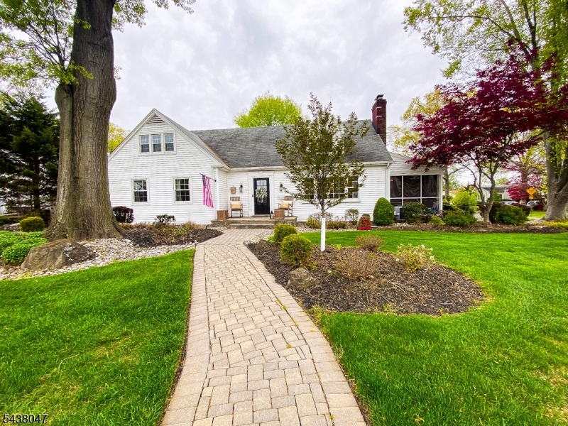 This distinctive custom oversized Cape Cod blends timeless charm with thoughtful modern upgrades across four bedrooms and two full baths. A welcoming entry foyer introduces a light-filled interior designed for both everyday comfort and elegant entertaining.The beautifully renovated eat-in kitchen is a standout, featuring stainless steel appliances, quartz countertops, custom finishes, and a built-in wine fridge. Seamlessly connected, the dining area opens to a raised paver patio and screened porch perfect for indoor-outdoor living and effortless hosting.The main level offers a spacious primary retreat with dual closets, an additional flexible bedroom or office, and a sunlit living room with rich hardwood floors and a wood-burning fireplace.Upstairs, two expansive bedrooms with sitting areas provide versatile living options, including potential secondary primary suites, complemented by a full bath and generous landing.The property continues to impress outdoors with professionally landscaped grounds, multiple paver patios, ambient lighting, and curated greenery creating a private, serene setting. Additional highlights include a finished basement with separate workspace, Bilco door access, a storage shed, and a fenced gravel area ideal for recreational or extra vehicle parking. Large corner lot with fenced yard. Driveway 3 cars wide/3 cars deepComplete with central air, and updated furnace, this home offers a combination of space, style, and functionality.