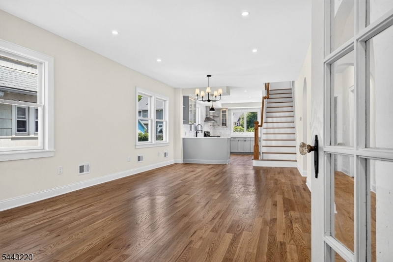 Welcome to 609 Harrison Avenue, where timeless character meets modern construction. Thoughtfully reconstructed in 2026, this custom Colonial offers the charm of a classic home with the quality and peace of mind of new construction. From the preserved arched front door and stone fa ade to the expanded floor plan with 9-foot ceilings, every detail was designed for today's lifestyle. Step inside to a bright, open-concept main level where the living, dining and kitchen areas flow seamlessly together. The designer kitchen features quartz countertops, soft-close cabinetry, GE stainless steel appliances, a deep Kohler sink and a built-in breakfast banquette. Solid oak hardwood floors, custom curved archways and thoughtfully selected finishes add warmth and character throughout. A first-floor bedroom and full bath provide flexibility for guests, multigenerational living or a home office. Upstairs, the spacious primary suite offers a large walk-in closet and spa-inspired bath, while two additional generously sized bedrooms, another full bath and second-floor laundry complete the upper level. The finished basement adds flexible living space. Beyond its beautiful finishes, this home features all-new major systems, including HVAC, plumbing, electrical, insulation, roof, Andersen windows and a tankless water heater. Conveniently located near schools, parks, shopping and major transportation, this is a rare opportunity to own a truly turnkey custom home.
