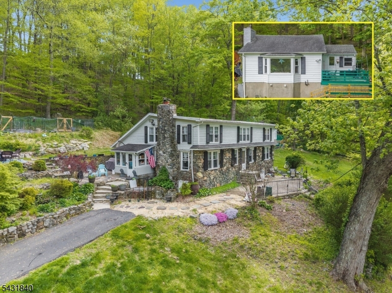 A STONE FRONT CIRCA-1885 4BR & 2 FULL BATH FARMHOUSE COLONIAL WITH A SEPARATE 1BR RENTAL COTTAGE AND ALSO A SMALL HEATED GYM ON A GORGEOUS 7.90 ACRE WOODLAND-ASSESSED LOT WITH A GREAT LOCATION A FEW HUNDRED YARDS DOWN THE ROAD FROM THE COLUMBIA TRAIL AND  THE PRISTINE FREE-FLOWING TROUT-FILLED  WATERS OF THE SOUTH BRANCH OF THE RARITAN JUST A BIT UPSTREAM FROM WHERE IT BEGINS TO FLOW THROUGH THE SPECTACULARLY SCENIC  KEN LOCKWOOD GORGE. THE CENTERPIECE HOME OF THIS UNIQUE COUNTRY HOME COMPOUND FEATURES A HUGE 15X15 BEAMED-CEILING COUNTRY KITCHEN WITH SOME STAINLESS APPLIANCES AND AN ATTRACTIVE SUBWAY TILE BACKSPLASH, THE HOME ALSO FEATURES A GREAT WIDE-OPEN FLOOR PLAN IN FRONT WITH A RAISED-HEARTH FLOOR-TO-CEILING STONE FIREPLACE IN THE FAMILY ROOM SECTION AND A FULL WALL OF WINDOWS AND BUILT-IN BOOKSHELVES IN THE DINING ROOM PORTION OF THE IMMENSE ROOM. ALSO ON THE FIRST FLOOR IS A POTENTIAL FIRST FLOOR IN-LAW SUITE COMPLETE WITH A SMALL BEDROOM, A FULL BATH, & AN ACCESSORY KITCHEN. THE SECOND FLOOR OFFERS AN ENORMOUS 22X16 MASTER BEDROOM, THREE EXTRAORDINARILY OVER-SIZED SECONDARY BEDROOMS, AND A SHARED HALL BATH. THE SEPARATE COTTAGE OFFERS A SINGLE BEDROOM, A FULL BATH, AND A LIVING ROOM WITH A LARGE VIEW-FACING PICTURE WINDOW AND A FIREPLACE. LARGE MULTI-LEVEL PATIOS ADD TO SUMMER FUN & DINING OPPORTUNITIES.