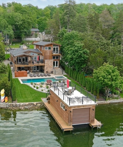 When only the best is good enough!  Luxury lakefront with everything you've been searching for...and more!!  Designed by the esteemed architect Karin Burke, this flexibly spacious home with 5 possible Bedrooms (3 BR septic) and 4 Full Baths, the floorplan is ideal for fine living & gracious entertaining.  This exceptional home is spread out over 3600 luxurious sq ft and offers 180' views of Lake Mohawk.  Laze the day away poolside, BBQing on the maintenance-free deck or drinking in lake views from atop your very own boathouse (complete with electric lift.)  (This the THE best spot for the Lake Mohawk 4th of July fireworks!) For more fun, head out on the boat for waterskiing, fishing or simply cruising.  Close to the beach, you can boat to the country club for dinner or walk to the Plaza.  In the winter, you'll enjoy the warmth of the stone fireplaces or ice skating on the Lake. All year long, you'll appreciate the newer construction w/custom features, natural gas heat, heated 14' garage, newer roof (2024,)16x32 saltwater pool & spa with soundproofed equipment housing (2022,) septic system (2018,) fencing & landscaping (2022,) Viking & Bosch appliances, remote controls for garage/pool/spa & have piece of mind with your Generac back up generator. Lots of parking with a 2.5 tandem garage, double driveway and extra large parking pad. You don't want to miss this extraordinary opportunity!