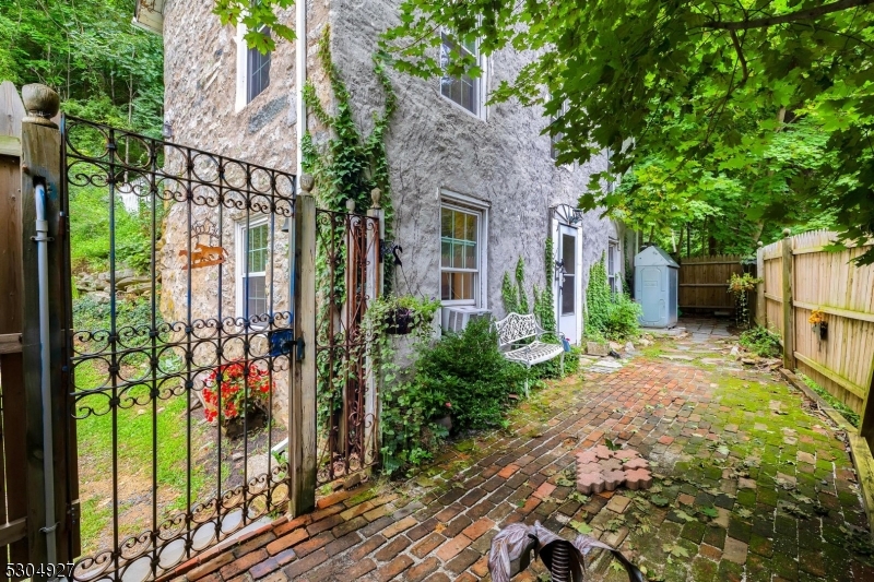 New price point!! Step Back in Time with Modern Comforts..Discover a storybook cottage nestled on a picturesque 3/4-acre lot in the heart of Long Valley. This enchanting 3-bedroom, 1.5-bath home, built around 1877, exudes the charm and character of a bygone era while offering thoughtful updates for today's lifestyle. As you step inside, the inviting warmth of a stunning stone fireplace sets the stage for cozy evenings, while original wood floors highlight the home's timeless appeal. The galley kitchen seamlessly blends historic charm with modern functionality, creating a delightful space for your culinary adventures. The charm continues outdoors, where a fenced yard offers privacy and a tranquil retreat. Whether you're hosting gatherings or enjoying quiet moments, the lush surroundings provide the perfect backdrop. Convenient off-street parking completes the package, ensuring practicality meets charm. With its old-world allure and contemporary comforts, this Long Valley gem is a rare find. Don't miss your opportunity to own a piece of Morris County's rich history. Schedule your tour today and experience this unique blend of past and present.