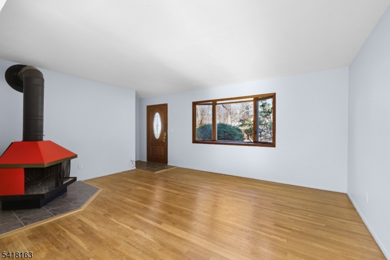 Discover the perfect blend of charm, convenience, and natural serenity at this move-in ready single-family home in the highly desirable Cupsaw Lake (membership Optional) area of Ringwood, NJ. Nestled in the heart of the scenic Ramapo Mountains and Skylands region just about 40 miles northwest of New York City, this cozy residence, sits on a generous 0.34-acre lot, offers peaceful, rural living with easy access to urban amenities. Gleaming white oak hardwood floors flow throughout, infusing the well-maintained interior with timeless warmth and an inviting atmosphere that requires no immediate updates. Enjoy the finished basement and step outside to your private backyard oasis, featuring a picturesque small pond exclusive to the property, where you can relax with morning coffee, enjoy tranquil water views, or simply unwind amid nature's beauty in your fenced retreat. Ideal for first-time buyers, downsizers, or anyone craving a quiet, nature-oriented lifestyle, this home sits in a tight-knit, friendly community surrounded by state parks, hiking trails, the New Jersey Botanical Garden at Skylands, and year-round lake activities. Embrace the best of Ringwood's low-crime, welcoming vibe and outdoor paradise don't miss this rare opportunity to own a slice of tranquil lakeside living.