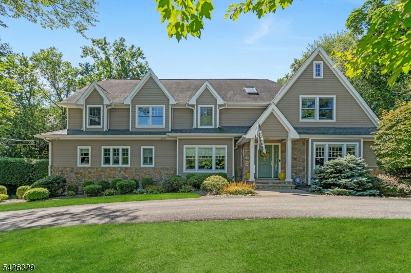 Welcome to 7 Deerhill Drive, a stunning modern Colonial offering 5 bedrooms, 5 full baths, and 1 half bath, blending timeless design with modern comfort throughout. An open-concept layout is ideal for everyday living and entertaining, featuring a gourmet kitchen with oversized island, coffee bar, and eat-in area that flows seamlessly into the inviting living room with a natural stone fireplace. Formal living and dining rooms, along with a flexible main-level space with full bath, add both elegance and versatility. Upstairs, the luxurious primary suite offers a serene retreat with an expansive walk-in closet, accompanied by three additional guest bedrooms designed for comfort and flexibility. A bonus room offers flexible space for a playroom, office, or additional lounge area. The walk-out lower level enhances the home's appeal with a recreation area, wet bar, full bath, and access to the 3-car garage. Outdoors, a private backyard oasis awaits, featuring mature landscape, an in-ground pool, outdoor fireplace, and built-in grill perfect for entertaining and enjoying the best of indoor-outdoor living. A lifestyle waiting to be experienced!