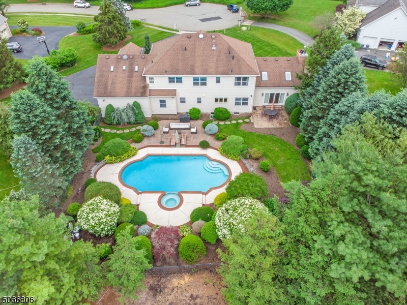 Nestled in one of Denville's most desirable neighborhoods, this home offers an upscale lifestyle on the end of quiet Cul-De-Sac. Stately Colonial, Understated Elegance! Prominently set on large, level lot. Over 1 acre. Many stunning features throughout. A grand home accented w/ architectural details; high, tray ceilings, custom woodwork, built-ins & wide trim & ornate moldings. Updated kitchen w/granite & gourmet SS appliances. Formal Dining & Living Rooms. Striking 2 story Foyer & Great Room w/fireplace, skylights & French Doors to Patio. 1st floor bdrm/office. Master includes large bath, walk-in closet & sitting area. 3 more spacious bdrms. Huge finished bsmt bonus w/recreation, media room, exercise & wet bar. 3 car garage & attic. Paver patio & landscaped backyard oasis w/gorgeous in-ground pool.