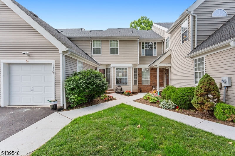 Move right into this beautifully maintained Americana model townhome in Whitehouse Village featuring 2 bedrooms, 2.5 baths, and a finished basement, all backing to woods for exceptional privacy and tranquil views. The main level offers an eat-in kitchen with stainless steel appliances, pantry storage, and a tile backsplash, along with an open-concept dining and living room highlighted by a soaring cathedral ceiling, skylight, gas fireplace, and sliding door leading to a private deck with a gas line hookup for your grill. Luxury vinyl flooring runs throughout the first floor, which also includes a convenient powder room and laundry closet. Upstairs, both bedrooms feature en suite baths, including a spacious primary suite with a walk-in closet. The finished basement provides flexible space for a recreation room, home office, gym, or media room, plus a separate storage room. A one-car garage and driveway parking add convenience. Enjoy community amenities including a pool, tennis courts, and clubhouse. Convenient paths connect you to the best of Whitehouse Station-- one path leads to Starbucks and Kings, while another provides access to Main Street and the NJ Transit train station. Additional highlights include a new roof and an ideal location near Routes 22, 78, and 287, NYC transportation, shopping, dining, and top-rated schools with full-day kindergarten.