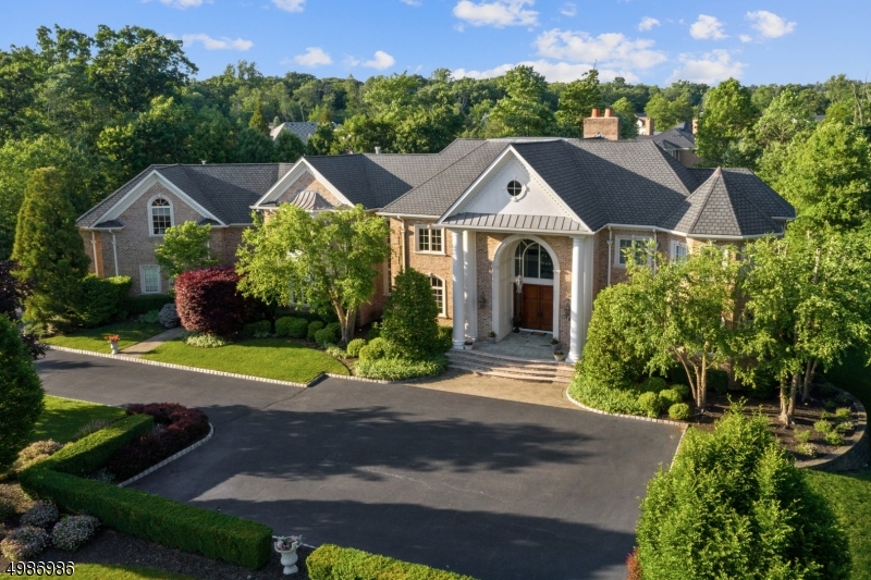 Exquisite custom colonial sits majestically on over 1.5 acres of property. Unparalleled craftsmanship & exceptional amenities. Truly remarkable inside & out. From the moment you enter the two story entry to the resort oasis outside, the attention to detail prevails. Cathedral ceilings, chef's kitchen, master bedroom retreat w/spa-like bath & sitting area, stunning moldings, billiard room, 2 fireplaces, 3 car heated garage,  main floor guest suite, lower level w/high ceilings, wet bar, wine cellar, craft room, bed/bath & workshop are just a few fabulous features. Spectacular yard offers heated pool w/flowing water, hot tub, waterfall slide, firepit, outdoor kitchen & music. Entertainers delight! Not a stone unturned. Amazing floor plan! Conveniently located near NYC transportation & highly ranked schools.