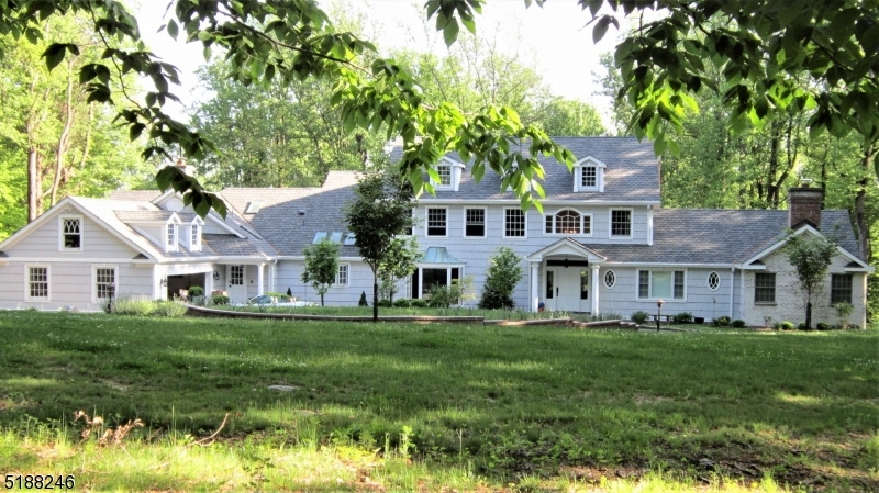 Quiet country road in neighborhood w beautiful New England repro colonial.  Completely updated and renovated in 2018 with high end detail.  Indoor pool area w/sauna 46 x 24 for year around enjoyment and sliders to terrace for summer. 34 x 15 Designer kitchen with wine cooler, Wolfe oven, White Dolomite counters, large pantry and expansive eating area leading to French doors and private patio. FR is adjacent with FP and spacious LR with FP opp clerestory entry foyer.  A third FP graces the beautiful first floor Primary suite with soaking tub and shower and 2 walk-in closets. 2nd fl laundry room for 4 Brs and stairs to full attic. The upstairs floorplan provides for 2BR sharing a bath at one end, one ensuite in the middle and one used as an office or BR over the pool mechanical area  There is also a 2nd level storage room for luggage.  Newer roof, 6 BR septic (2017) .  Full rear mudroom with outside entrance and garage entry/back stairs.  The acreage is tiered out the back with 2 levels and plenty of room for a great BBQ Sunday... low low low electric bills with owned solar panels very unobtrusively located. Squ ft does not include pool area which would yield 6800 squ ft.  Listing is as per town info..