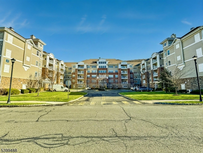 Wonderful 1st floor condo at Wanaque Reserve that has a 24 hour gated 55+ community with a scenic private location with wonderful park like views. This spacious 1768 square foot Colfax model offers 3 elevators per building, an open-concept living, a light-filled living room and kitchen with double sliding glass doors leading to a private balcony. Spacious formal dining room for entertaining, loads of natural sunlight, and the bonus office/guest room with French doors. Primary bedroom is a suite with a large walk-in closet and separate dressing area. Set on 435 acres, Wanaque Reserve offers a 20,000 sq. ft. clubhouse with indoor/outdoor pools, a fitness center, theater, sauna, tennis & bocce courts, walking trails, and more. A Must See!