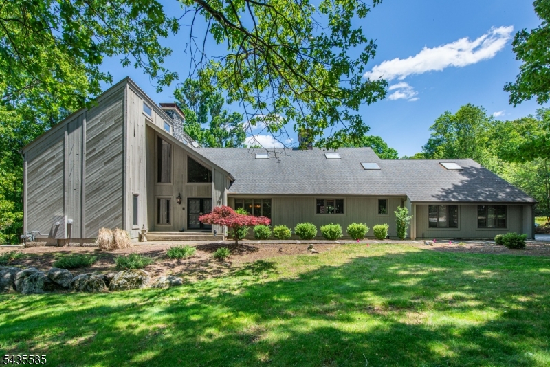 Impressive contemporary home offering 5,412 sq. feet of living space, ideally situated on an idyllic one acre lot!  Soaring cathedral ceilings, walls of windows, and 4 fireplaces add warmth and architectural character! The numerous gathering spaces are ideal for everyday living and entertaining, flowing seamlessly to the outdoor living space, where an inground pool and deck create a relaxing oasis.  Generously sized bedrooms each feature private en-suite bathrooms, individual balconies, & ample closet space.This distinctive home features a two-story foyer, leading to the living room with two-story stone fireplace. First floor primary suite with full bathroom, dressing area, & walk-in closet.  First floor office/potential guest rm. Formal DR and family room with brick fireplace.  Spacious EIK with ample cabinet & counter space, center island, & stainless steel appliances. Breakfast nook w/sliders to deck overlooking the inground pool. The second floor has three additional bedrooms plus a huge bonus room with a two-sided brick fireplace.  Ideal for home office or private guest suite, as it leads to BR 4, with ensuite full bathroom and separate staircase to first floor. A loft with a fireplace overlooks the living room.Perfectly position on a quiet cul d'sac, this amazing home offers a combination of privacy and convenience to schools, shopping, and commuter routes! Natural gas heat; new boiler; CAC; wholehouse generator; three car garage! Fireplaces as is.
