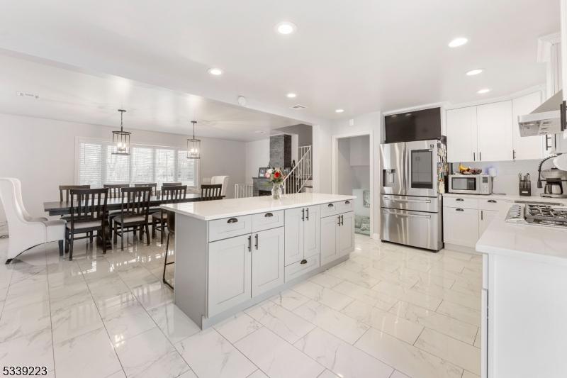 Stunning Split-Level Home, Fully Renovated with Modern Upgrades and Move-In Ready! This gorgeous home welcomes you with a bright and inviting living room along with a fully renovated bathroom perfect for entertaining. Upstairs on the first floor, you'll find a brand-new kitchen with quartz countertops, a massive center island, ample cabinet space, and an open-concept design that flows seamlessly into the formal dining area with a cozy fireplace. The kitchen opens to a spacious backyard with a new fence installed in 2022, a great deck, and an in-ground pool perfect for outdoor fun for the upcoming summer days. The second floor boasts three well-sized bedrooms and a stunning full bath with a large stand-up shower, all beautifully updated in 2021. The finished basement offers two additional rooms with endless possibilities, ideal for a home office, gym, or playroom, along with a dedicated laundry area. A new roof and gutters were installed in 2022, along with a new furnace with central air and heat for added energy efficiency. Plenty of parking is available with a built-in garage and a driveway that fits three to four cars. Conveniently located less than a mile from the train station, this home is perfect for commuters and is close to schools and shopping. A Must See!