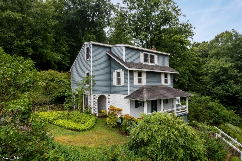 Step back in time & experience the charm of this remarkable antique home, originally built in 1743 as a 2-room fieldstone residence. Rich in character & history, this unique property has been expanded over the years. Today, the home offers 8 spacious rooms, including 4 bedrooms & office. The kitchen showcases a beautiful beamed ceiling & opens to a covered porch, creating the perfect spot for coffee or outdoor dining. The inviting living room also features exposed beams & is accessed from the welcoming covered front porch. An exceptionally large dining room, highlighted by a wood-burning stove, provides a wonderful gathering space for holidays, entertaining, or everyday living. A third-floor addition completed in 1989 adds 2 bedrooms, a full bath with a whirlpool tub, & a large walk-in hallway closet, offering flexible living space. The grounds are equally impressive, featuring 2 covered porches, a covered side patio, a fenced vegetable garden & a 1/3 paved basketball court. Throughout the spring & summer, the property comes alive with an array of beautiful flowering plants, mature landscaping, & blooming trees that create a colorful & serene setting. Energy-efficient windows enhance comfort throughout the home, while seasonal views from the front & side porches provide a picturesque backdrop year-round. This one-of-a-kind property offers a rare opportunity to own a piece of american history while enjoying the comforts of today's lifestyle.
