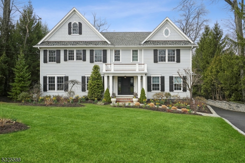 Nestled in Ridgewood's prestigious Country Club section, this expansive 5-bedroom, 5.1-bathroom home offers elegance, modern convenience, and stunning outdoor living. Inside, soaring ceilings and an open layout enhance the home's grandeur. The designer eat-in kitchen boasts high-end appliances, while the first floor features a great room, family room, dining room, sitting room, and a bedroom with a full bath. Upstairs, the luxurious primary suite includes a sitting area, dressing room, spa-like bath with a steam shower and soaking tub, and large windows overlooking the picturesque backyard. 3 additional bedrooms and 2 bathrooms complete the second floor. The lower level offers a gym, rec room, office, bonus room, storage, and full bath. A 3-car garage, whole-house generator, and sprinkler system complete this exceptional property. Enjoy the beautifully landscaped yard, fully fenced for privacy, with a heated saltwater pool, lush gardens, and direct access to the neighboring park. Multiple porches and a spacious deck with a gas grill hookup provide the perfect setting for outdoor dining and relaxation.