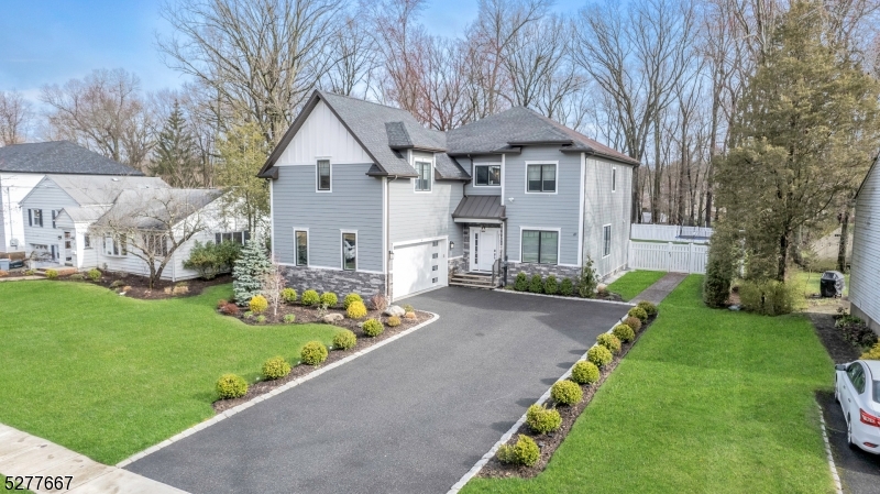 Introducing a stunning five-year-old six-bedroom, 5 1/2 bathroom house in a prime location. As you enter, you are welcomed by a grand two-story foyer adorned with beautiful woodwork, trim, and moldings. The first floor boasts 10-foot ceilings, enhancing the spacious and luxurious feel of the home. The gourmet chef kitchen features quartz countertops and a waterfall feature on the center island. Top-of-the-line appliances are perfect for meal preparation and entertaining.The open floor plan seamlessly connects the kitchen to the dining room, living room, and family room, where sliding doors lead out to the paver patio, outdoor kitchen, and expansive .39-acre flat level fenced-in property. Upstairs, you will find five bedrooms, including a gorgeous master suite with a spa-like bathroom showcasing a soaking tub and stall shower. The second floor features 9-foot ceilings, adding to the airy ambiance of the home.The basement is a true entertainer's delight, complete with a wet bar, large rec room area ideal for a home gym, and a separate media room for movie nights. This property offers convenience with its proximity to New York transportation, the town center, schools, and shopping amenities. Don't miss the opportunity to own this exquisite home that epitomizes modern luxury living.
