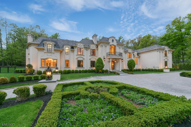 Enter through the magnificent double story entrance foyer into this French Manor estate boasting exquisite museum quality millwork and custom natural stone flooring throughout. Featuring 6 spacious bedrooms each with their own private ensuite bathrooms, plus an additional 2 full and 2 half bathrooms. The luxurious master suite with fireplace features a sitting room, private balcony, two massive walk-in closets and an incredible spa-like master bathroom. The grand ballroom with fireplace and wet bar are truly one of a kind. The great room with fireplace and floor-to-ceiling windows, formal dining room, Chef's eat-in kitchen, family room, study with fireplace, mud room, pantry and elevator to all floors are just a few of the custom features throughout this palatial estate.