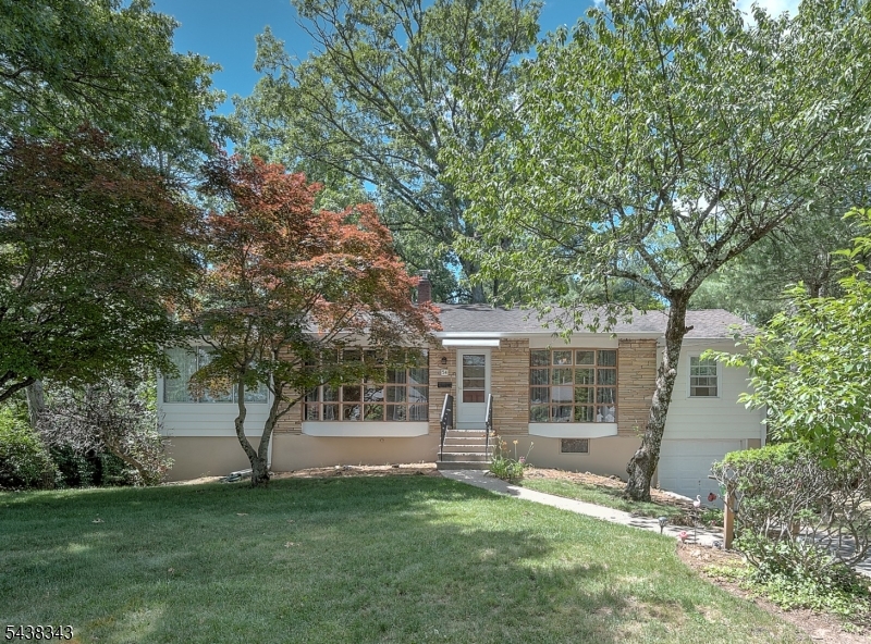 Lovingly cared for home on  beautiful flat property that backs to the woods. Eat in Kitchen, hardwood floors under carpeting, large primary suite with full bathroom and an additional half bathroom with potential to become a full bath. large living room and dining room each with a bay window. The dining room has two original charming corner cabinets. The enclosed porch is a perfect den/family room right off of the living room. The walkout basement is ready to be finished and will make a great additional space, possibly add an additional bedroom and bath.The home has great potential and is waiting for its next owner to make it their own. Convenient to NY transportation, parks, restaurants, shopping and the South Mountain Recreational Complex with all it has to offer.
