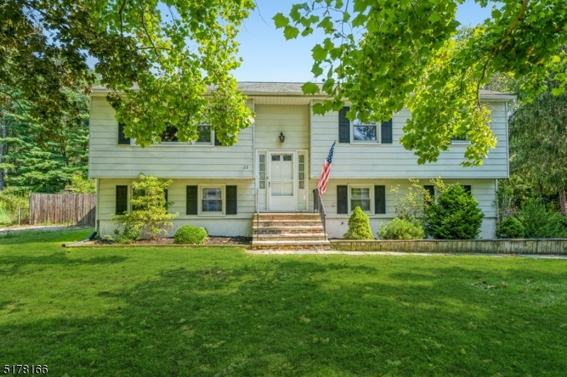 A spacious design on an oversized lot in Warren County!  Welcome home to this move-in ready Bi-Level with four bedrooms, two full bathrooms, an attached two-car garage, and an in-ground swimming pool. Built on a corner lot on a quiet, tree-lined street in a rural setting, this home is near a Walmart Super Center, a State Game Farm, M&M Mars Chocolate Factory, Centenary University, and two brewery tasting rooms. A manicured front lawn and walkway lead you inside to the light and bright interior with hardwood floors and an open floor plan. The large, sunny living room flows to the open dining area and a spacious eat-in kitchen. The kitchen features warm oak cabinets, generous counter space, stainless steel appliances, and a cozy breakfast corner. Down the hall is the primary bedroom, two additional bedrooms, and a full hall bathroom. The lower level contains a fourth bedroom, laundry room, access to the attached garage, and a full bathroom off the sun-filled family room. Double sliding glass doors bring in lots of natural light and open to a fabulous back yard including a multi-level patio with plenty of space for outdoor cooking, dining, and entertaining. Beyond the patio is a built-in fire pit, a large storage shed, and a refreshing in-ground pool that is fully fenced and surrounded by a wide pool patio. This home has it all and is ready to be enjoyed!