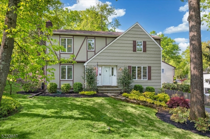 Gorgeous Updated Colonial in a Dream Location! 3 bedrooms, 2.5 baths, attached 2-car garage, and abundant natural light throughout, this beautiful home is set is close to everything including downtown shopping and dining, top rated schools, and numerous parks, as well as highways and NJ Transit trains for easy commutes. As you enter, you're greeted by a welcoming foyer that opens to a spacious formal living room with tall windows and showcasing the gleaming hardwood floors seen through much of the main level. A formal dining room with chair rail detail has direct flow into an eat-in kitchen equipped with rich wood cabinets, recessed lighting, granite counters, center island, stainless steel appliances, and a cozy breakfast nook nestled in front of windows with views of the backyard. Next is an elegant family room with a wood burning fireplace and sliding glass doors out to the large deck and fenced backyard beyond for effortless indoor-outdoor entertaining. A discreet powder room is tucked in the corner, completing this level. Upstairs you'll find 3 generously sized bedrooms with plush carpeting including an oversized primary with adjoining room that can be used as a nursery, office space, or a personal gym, as well as a full en-suite bath with tub and extra-wide vanity. Down the hall is the second full bath with wood storage vanity. The unfinished basement level houses the laundry, plus utilities, garage access, and ample space for storage.