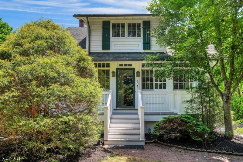 Step back in time and fall in love with the timeless charm of this circa 1905 Arts & Crafts Colonial in the heart of Stirling. Rich in character & architectural details, this inviting home features beautiful hardwood floors, original wood trim & craftsmanship throughout. The enclosed year-round front porch, enhanced with abundant windows & a split-unit HVAC system, provides a wonderful space to relax in every season. The first floor offers a welcoming living room, formal dining room, eat-in kitchen & a flexible office or den. Upstairs, one bedroom features a charming built-in bed, white a delightful second-floor sleeping porch provides the perfect retreat for reading or enjoying warm summer evenings. A finished lower level adds flexibility and comfort and a freshly painted exterior. Situated on a beautifully landscaped & private .40 acre lot, complete with a lovely paver patio, the home boasts a stunning level backyard with plenty of room for entertaining, gardening, or simply enjoying the privacy of the expansive yard. Additional highlights include a whole-house generator, providing peace of mind & convenience year round. Conveniently located near highly rated schools, downtown Stirling shops & restaurants, parks, & recreations facilities, this home offers easy access to major highways and the Stirling train station for a convenient commute to NYC. A rare opportunity to own a home that beautifully combines historic charm, modern comfort, and unbeatable location.