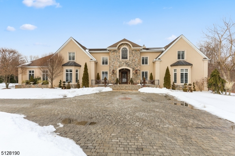 Take splendor in this magnificent 15,000 sf Tuscan villa in the prestigious neighborhood of Hawk Hill.  Situated on 2.7 acres at the end of a cul de sac and surrounded by 80 acres of green space, this home offers ultimate privacy and luxury.  The backyard is a true oasis featuring a heated in ground pool. There is extensive outdoor landscaping. This dream home features 6 ensuite bedrooms, 7 full and 3 half baths, 3 kitchens, 5 gas fireplaces, 5 garage spaces.  The primary bedroom has a sitting area with fireplace and wet bar. The main kitchen is eat in and a chef's delight with custom wood cabinetry, granite counter tops, and Viking appliances.  The kitchen/family room has a fireplace and doors out to a gorgeous, elevated deck overlooking the beautiful backyard.  Entertain in the spacious formal dining and living rooms which boast gorgeous Bordeaux, wood flooring.  The living room has a wet bar, 200 bottle wine fridge and soaring marble fireplace.  There are 2 offices which suits todays work at home environment. Downstairs is another full living space complete with bedroom and full bath, beautiful eat in kitchen, family room with tin ceiling, recreation/game area, media room with surround sound, sauna, full "pool  bath, home gym, 3,000 bottle wine cellar and huge wet bar.  This is an amazing space for at home fun, entertaining guests, or even an in law suite.  Go outside from this lower level onto a beautiful outdoor, covered patio complete with outdoor kitchen.