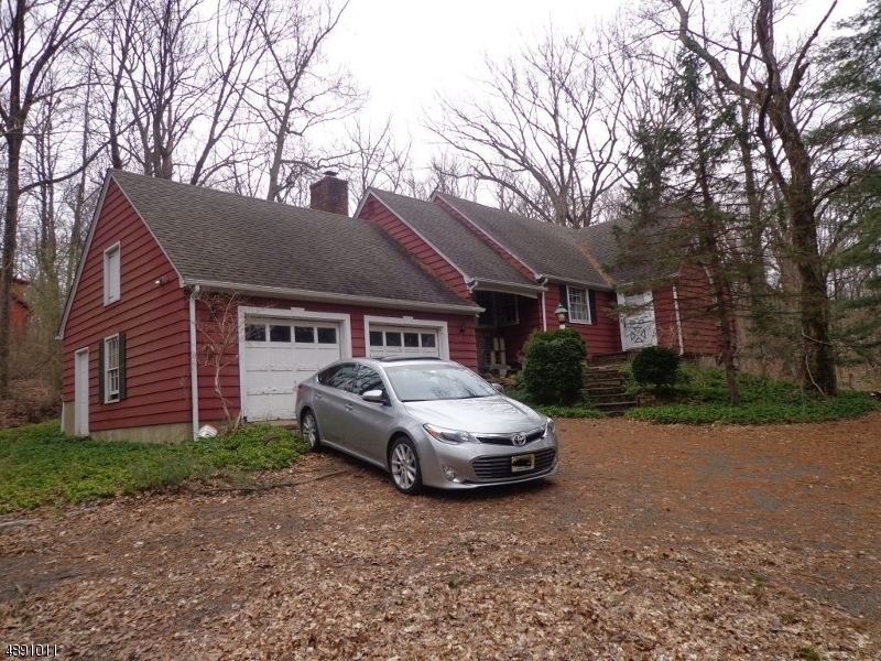 Property is being sold "as is." Home needs some work and updating. Great opportunity to own in Watchung! 1st floor consists of Eat-in kitchen, living room, dining room, den w/ fireplace, 1 full bath and 1 bedroom. 2nd floor consists of 3 bedrooms and 1 full bath. Lot is mainly wooded and is 1.8 acres. New roof in 2009. Walk-out full basement that is partially finished as an added family room and also has a laundry rm/workshop. 2 car attached garage. Driveway is partially shared.