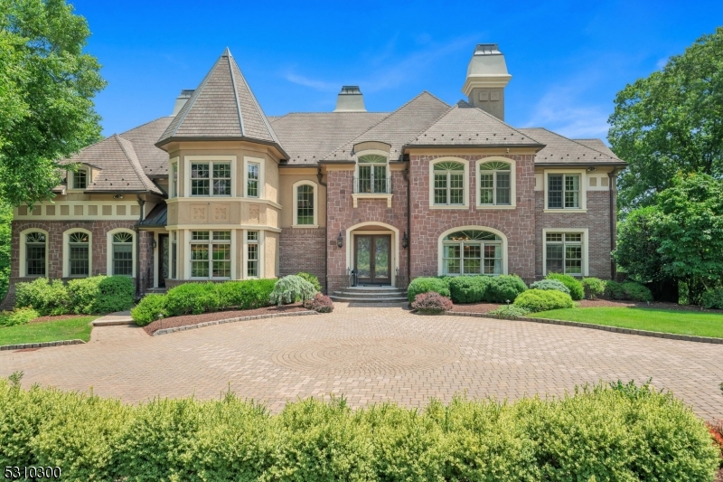Experience luxury living in this timeless French chateau inspired home, nestled in the highly sought-after Estates at Valhalla. Recent updates include a gourmet kitchen with a spacious pantry, an inviting inground pool, a grand foyer & a chic powder room. Every detail has been meticulously crafted w/ high-quality finishes, custom moldings, and Brazilian cherry hardwood floors. The first floor welcomes you with a formal living room, adjacent is a versatile game room, ideal for fun and relaxation. The formal dining room sets the stage for memorable meals, while the family room offers a cozy retreat. A private office provides a quiet space for work or study, and the brand new gourmet kitchen is a chef's dream, featuring top-of-the-line appliances and finishes. The great room w/custom built-ins, flows seamlessly to the newer deck, overlooking the lush, landscaped yard. A guest suite on this level offers comfortable accommodation. The second floor features a primary bedroom with two walk-in closets, a sitting room with a coffee bar and fireplace, and a lavish primary bathroom with a huge walk-in shower and dual sinks. Three additional bedrooms and two full bathrooms complete this floor. The fully finished walk-out basement boasts a large full wet bar, a gym, a full bathroom, mudroom and abundant storage. This exceptional home combines timeless elegance with modern luxury, offering an unparalleled lifestyle in the Estates at Valhalla.